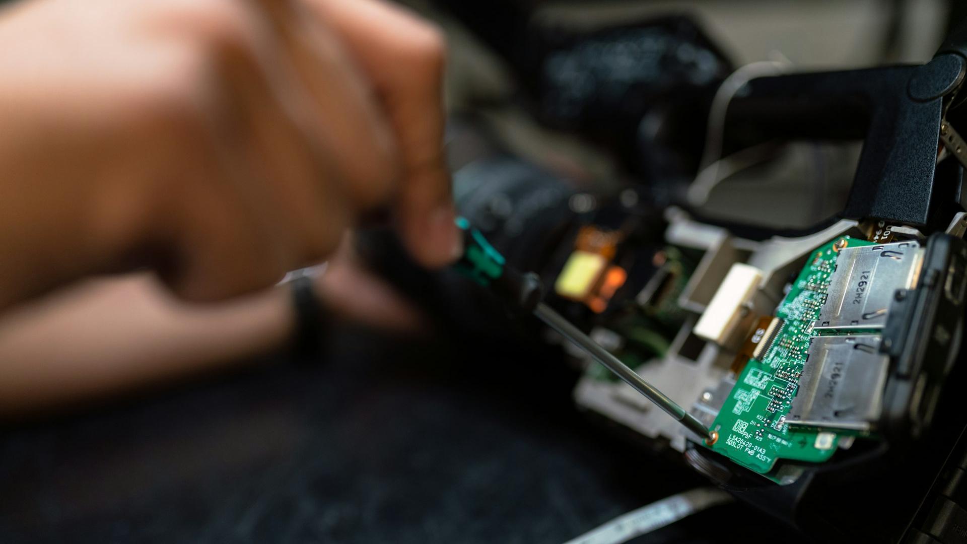 person holding green and black circuit board